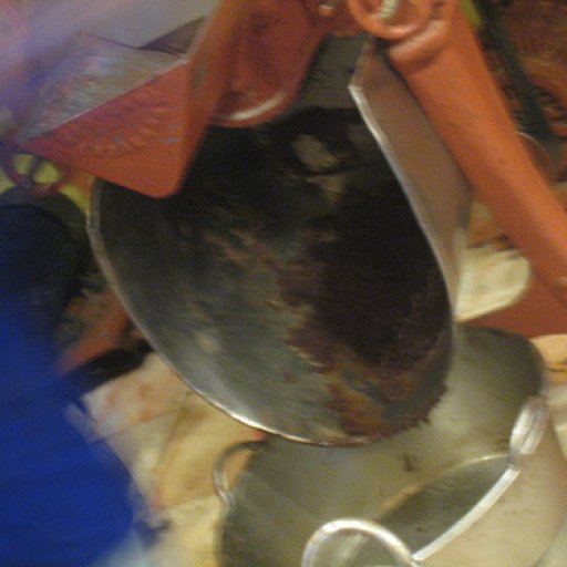 Chocolate falling onto sugar in Mayordomo grinder
