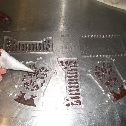 piping the moulds for chocolate cradle